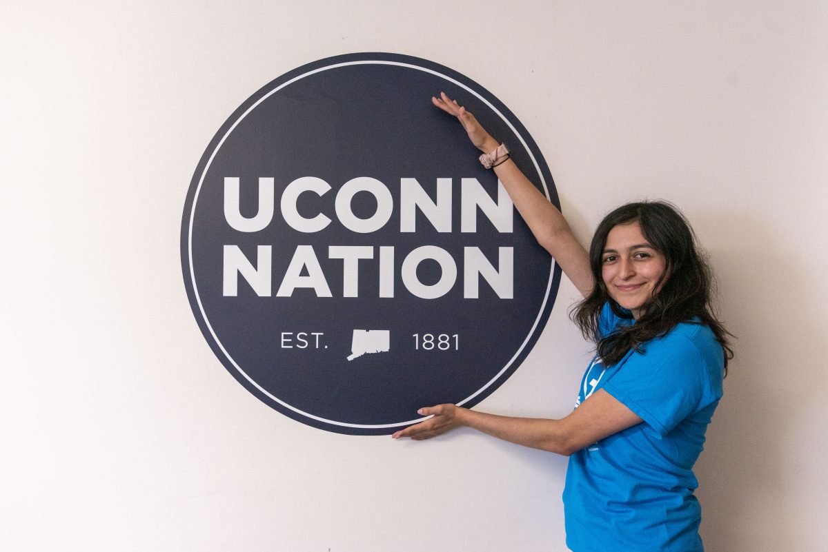 Student with a Uconn Nation sign at the Uconn Avery Point campus. April 14, 2022. (Sean Flynn)