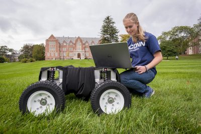 Emily Yale, one of the three inaugural students in our Master's of Engineering in Global Entrepreneurship program, with her autonomous robot at the Great Lawn on Oct. 7, 2019. (Sean Flynn/UConn Photo)