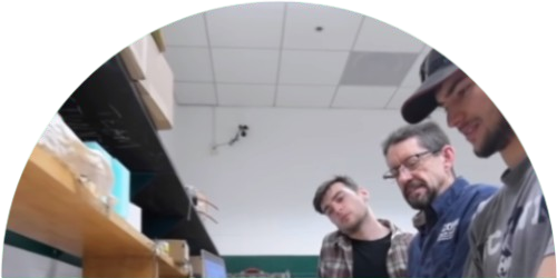 Teacher with students in a lab.