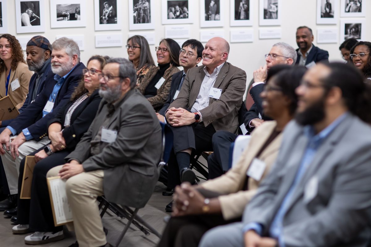People sitting on chairs listening to a speaker. 
