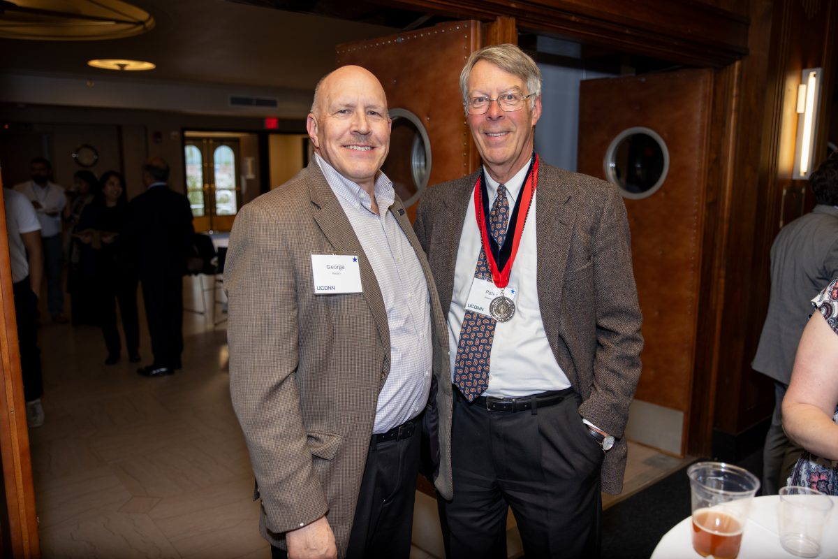 Two gentlemen posing for a picture.