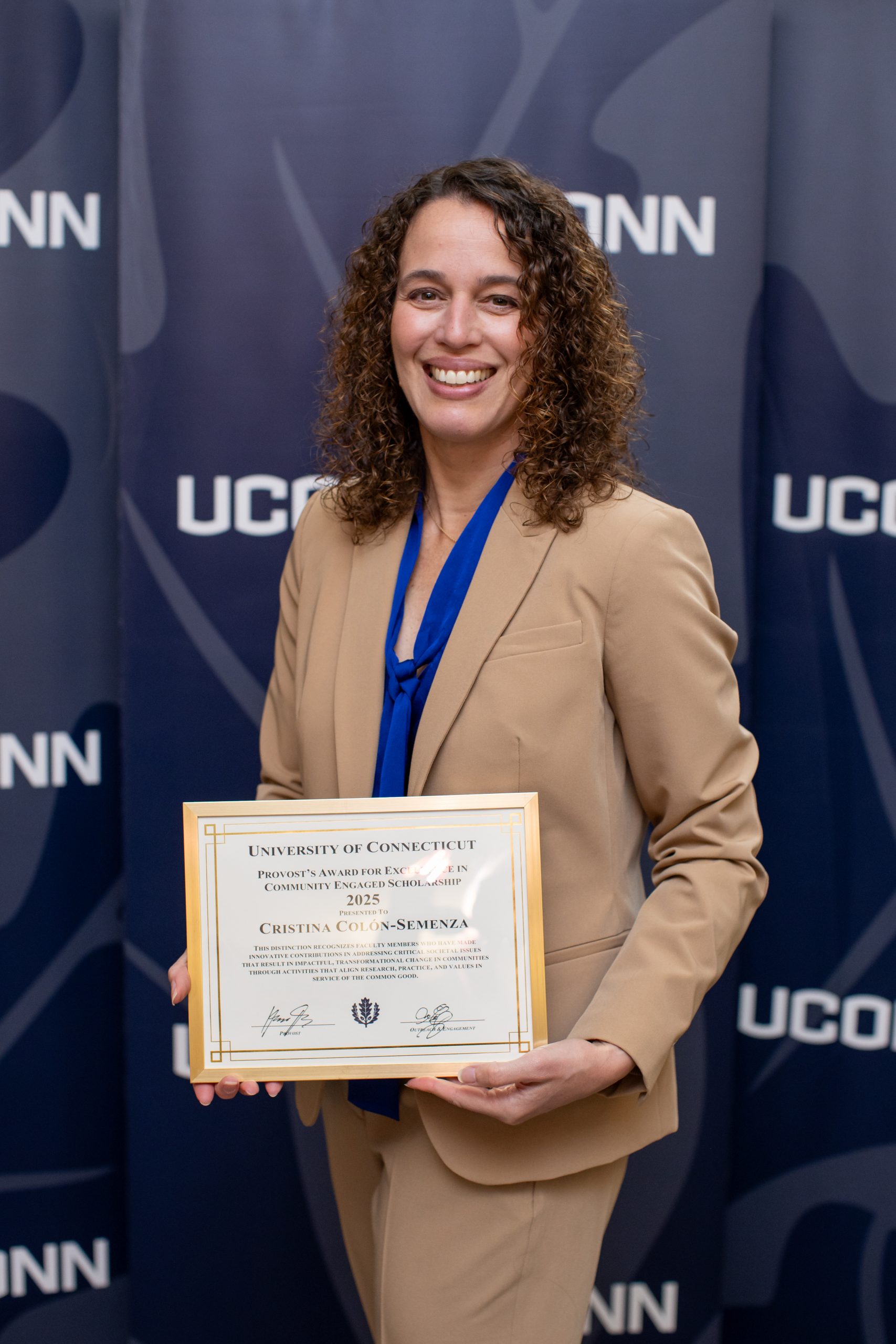 Professor Cristina Colon-Semenza with a UConn background